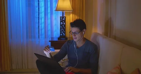 Young man with glasses buys online with a computer Stock Footage