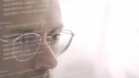 Young man in glasses coding intensely, Code in eyes, screen reflection, pro.. Stock Footage 289844438
