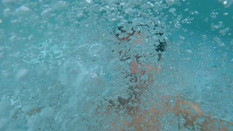 Young man glasses jumps into the pool during summer holidays in a tropical Stock Footage 235408209