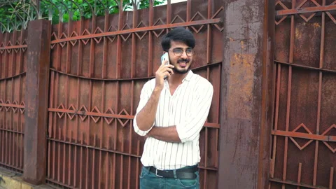 Young man with glasses talking on a smart phone Stock Footage 138676168