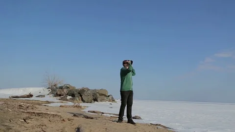 A young man with glasses virtual reality.Coast in the spring Video stock 75007451