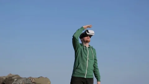 A young man with glasses virtual reality.Coast in the spring Stock-Footage 75007687