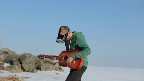 A young man with glasses virtual reality.Coast in the spring 動画素材 75008438