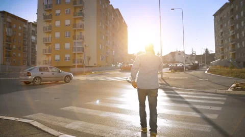 Young Man Go Across The Road in Hurry, Holding Mobile Phone Stock Footage 156005807