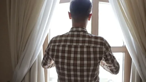Young man goes to the balcony Stock Footage 70886310