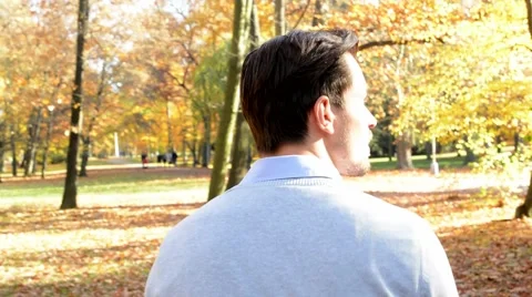 A young man goes through the woods, is turned back and looks around  Stock Footage 59725895