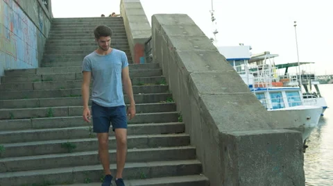 Young man going down stairs Stock Footage 68598969