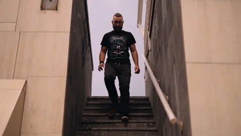 Young man going down the stairs Stock Footage 91687266