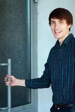 Young man going to enter Stock Photos