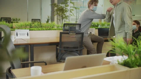 A young man is going to his desk and putting on a protective mask Stock Footage 159363747