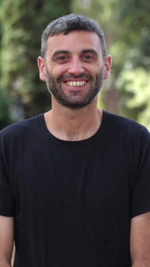 Young Man Going from Serious to Smiling in the Park Stock Footage 295143448