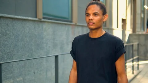 Young man going on the street slow motion Stock Footage 127859692