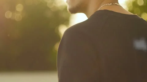 Young man going in the sunlight Stock Footage 96997533