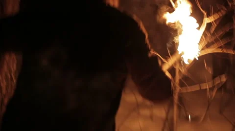 The young man going with the torch at night in the winter forest Stock Footage 64701798
