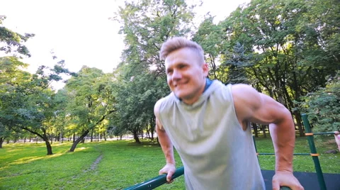 Young man in good physical shape, is engaged on the bars Video stock 64840283