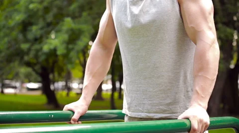 Young man in good physical shape, is engaged on the bars Stock Footage 64842501