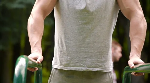 Young man in good physical shape, is engaged on the bars Video stock 64843074