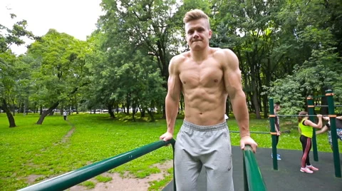 Young man in good physical shape, is engaged on the bars Stock Footage 64846460