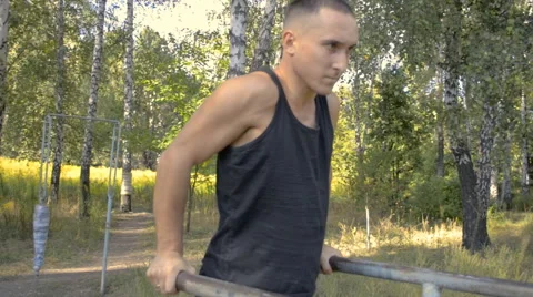 Young man in good physical shape, is engaged on the bars Stock Footage 67482131