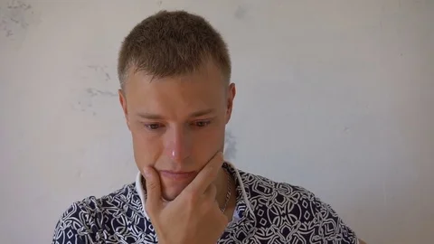 Young man got an idea in front of white wall Stock-Footage 79193751