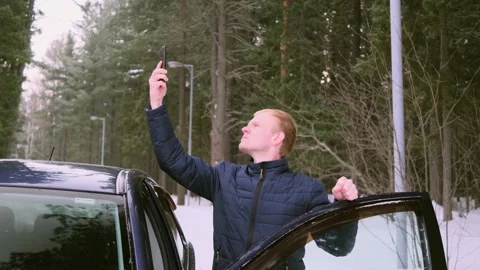 A young man got lost in a car in winter Stock Footage 150992880