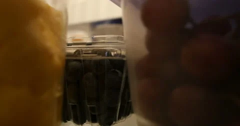 Young man grabs fruit out of the kitchen refrigerator. Ultra HD 4K Video stock 44407991