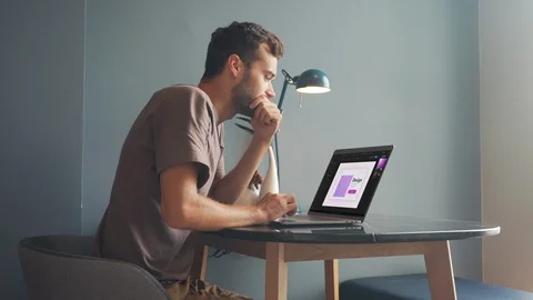 Young Man Graphic Designer Using Laptop, Typing, Looking at the Screen.  Stock Footage 120361828