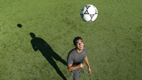 Young man on grass heading ball. Stock Footage 88048480