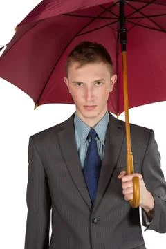 Young man in a gray jacket and red sneakers on a white background Stock Photos