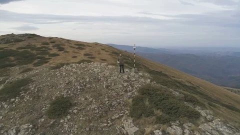 Young man with green jacket actively resting during trip enjoying freedom at Stock Footage 120515829