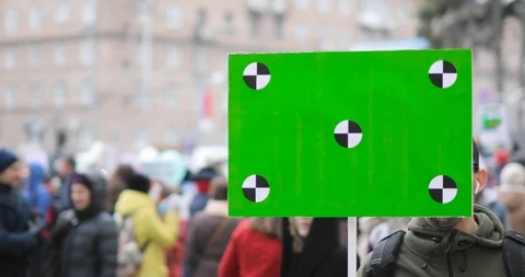 Young man with green screen poster in his hand on city demonstration. Stock Footage 107595639