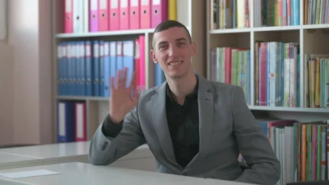 A young man greets you and gives you support for your every smart move Stock Footage 168937749