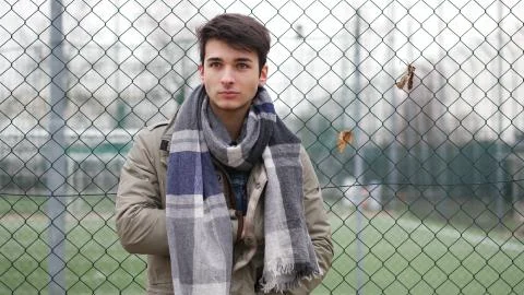 Young man at grid Stock Photos