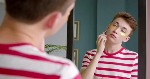 Young man guy does massage the face with a roller massager Stock Footage 135530270