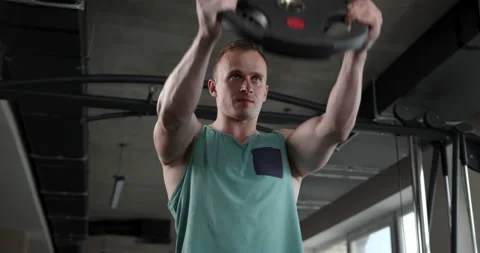 Young man in the gym doing exercise Stock Footage 158914577