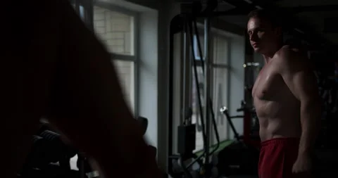  Young man in the gym posing tensing his muscles in front of the mirror. Stock Footage 158921458