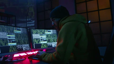 Young man hacker by computer in the dark room at night, cyberwar concept. Stock Footage 217424973