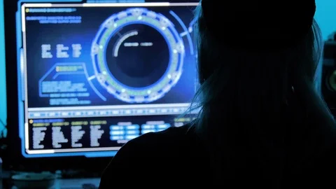 Young man hacking into the internet while looking at schematics Stock Footage 118977141