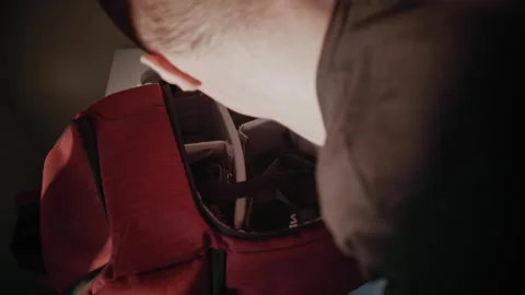 Young Man with Hand Disability Packing Camera Bag for Photo Walk Stock Footage 321939019