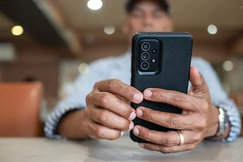 Young man hand holding cell phone. Close-up image of male hands using smart.. 스톡 사진