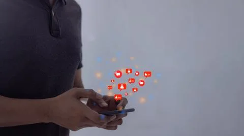 Young man hand Holding, Using smart phone mobile with Love, Follow and Comm.. Stock Photos