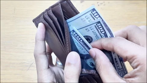 Young man hand take out one hundred dollar bills from his wallet Stock Footage 288974742