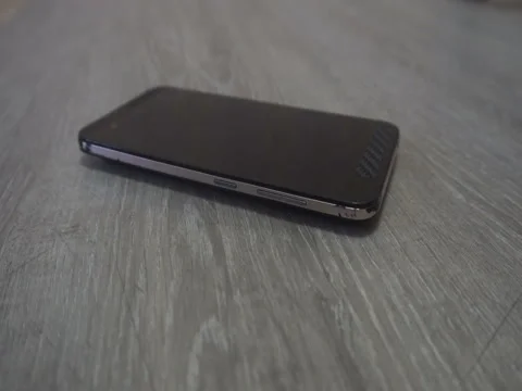 Young man hand takes mobile phone from grey background Stock Footage 83630316