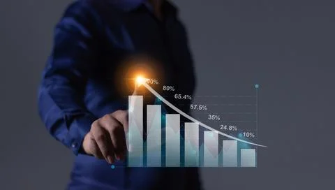 Young man hand touching to visualize money growth The screen displays graph.. Stock Photos