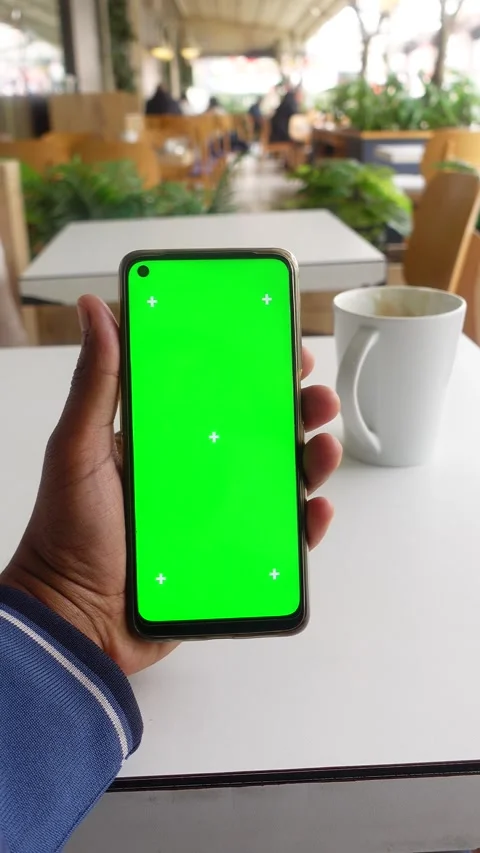 Young man hand using smart phone with green screen at cafe Stock Footage 266961376