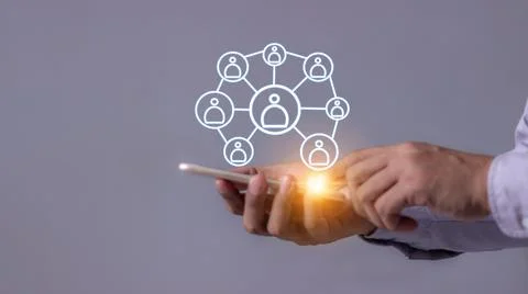 Young man hand using smartphone to Interconnect, Interconnected Concept; Pe.. Stock Photos