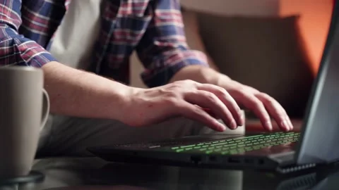 Young man hand work on laptop computer at home table close up shot Stock Footage 210552738