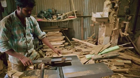 Young man handles woodworking machine with focus Stock Footage 313666839