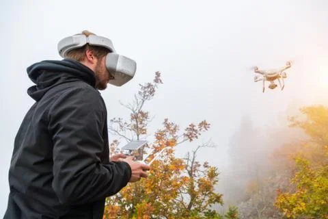 Young man handling drone, using virtual reality glasses. Stock Photos