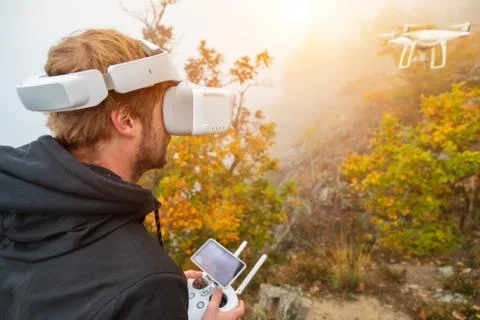 Young man handling drone, using virtual reality glasses. Stock Photos